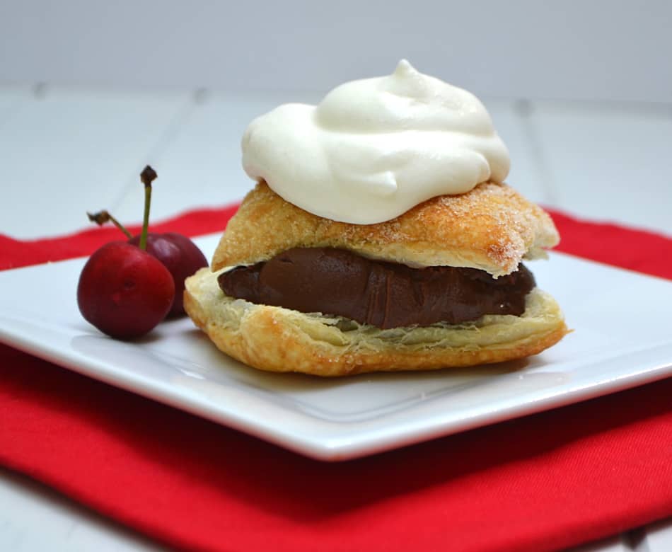 Rich chocolate ganache layered between flaky Puff Pastry and topped with homemade whipped cream. Absolute dessert perfection | www.craftycookingmama.com
