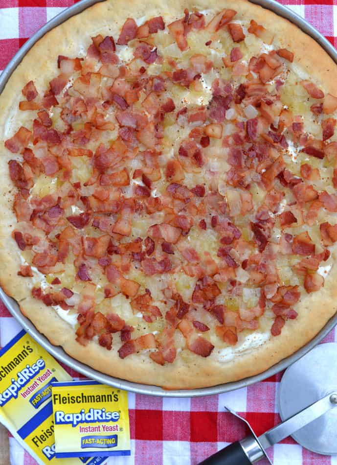 Flammkuchen - a traditional German pizza topped with creme fraiche and smothered in sauteed onions & crisp bacon.