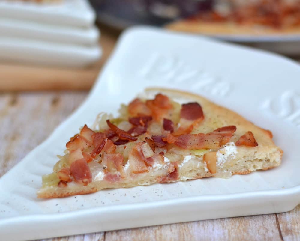 Flammkuchen - a traditional German pizza topped with creme fraiche and smothered in sauteed onions & crisp bacon.