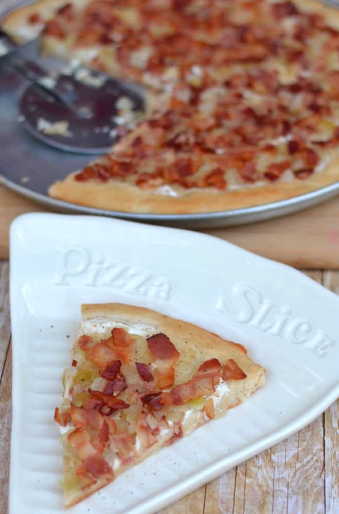 Flammkuchen - a traditional German pizza topped with creme fraiche and smothered in sauteed onions & crisp bacon.